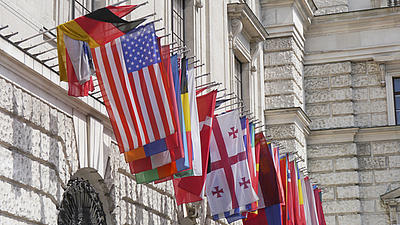 Waving flags on a governmental building.